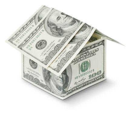 a house made out of money on a white background
