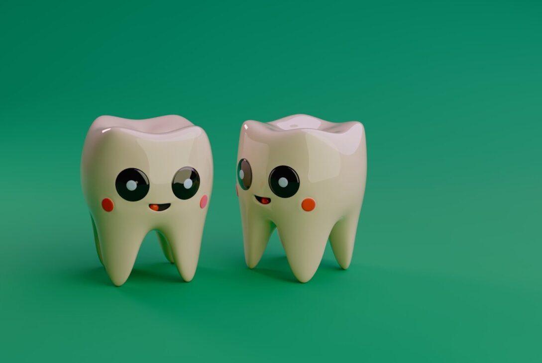 Two cartoon teeth smiling on a green background