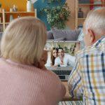 Elderly couple video calling with family at home.