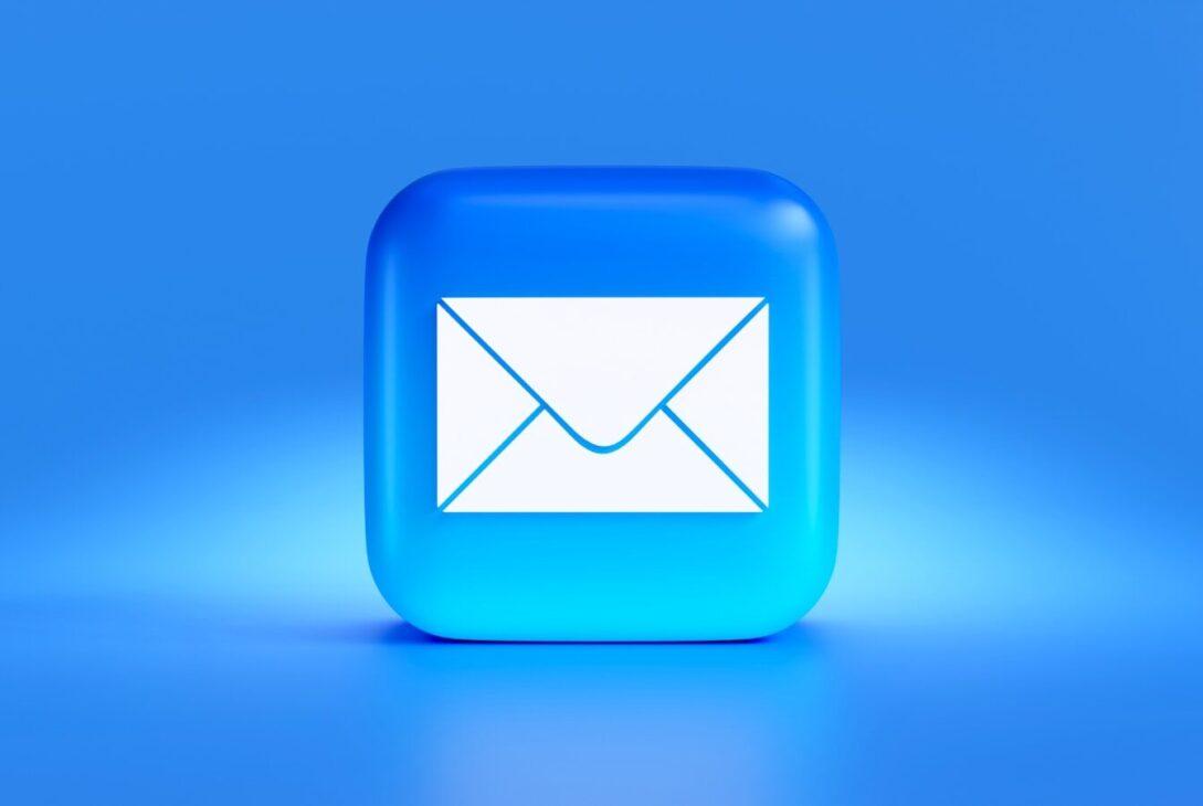 a blue button with a white envelope on it