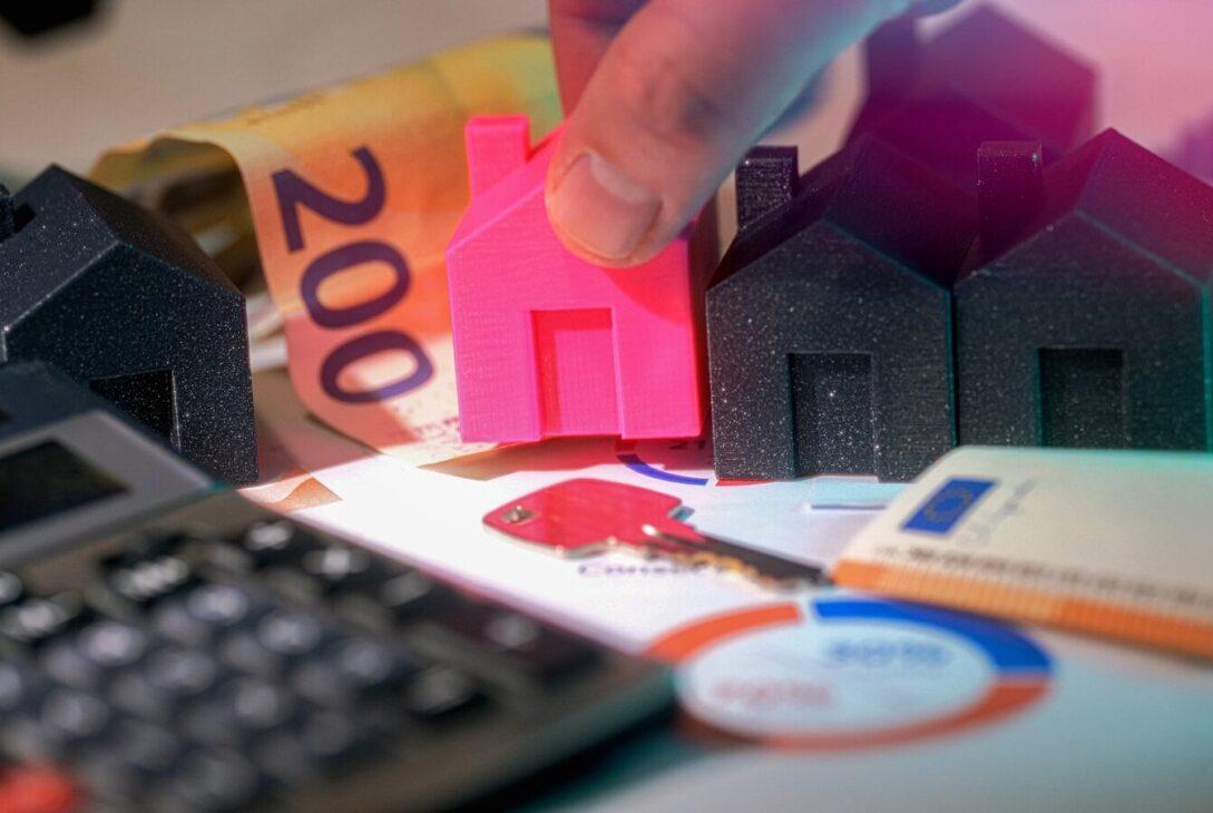 Real estate investment shown with houses and money.
