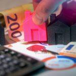 Real estate investment shown with houses and money.
