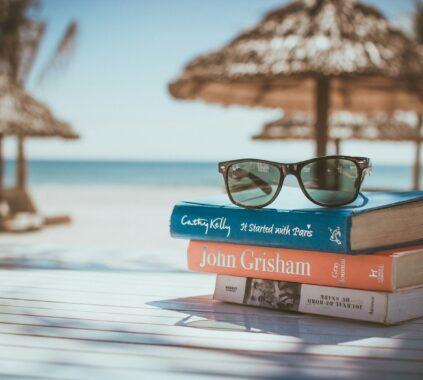 black framed Ray-Ban Wayfarer sunglasses on top of book