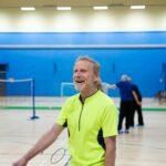 Man smiling in a badminton court